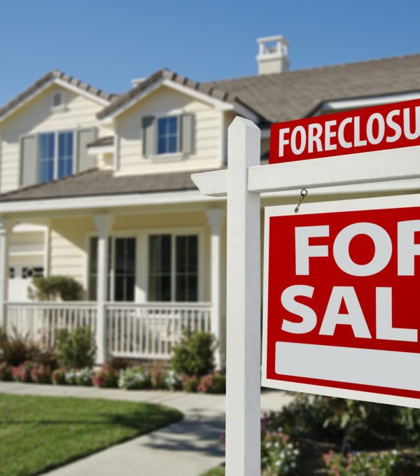 Foreclosure Home For Sale Sign in Front of Beautiful House.